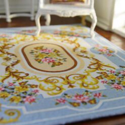 Soft blue Aubusson floral rug with roses and golden detailing