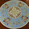 Classic Aubusson miniature rug with floral motifs and ornate borders in muted tones