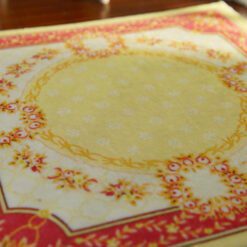 Miniature Aubusson square rug with floral border and yellow center.