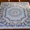 Modern Aubusson-style miniature rug with floral motifs in blue, pink, and cream