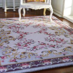 Aubusson-style miniature rug with floral scrolls in soft pastel colors