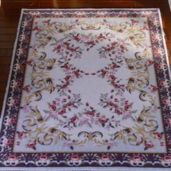 Aubusson-style miniature rug with floral scrolls in soft pastel colors