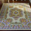 French-inspired miniature rug with intricate floral motifs in yellow, purple, and cream
