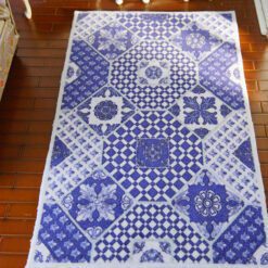Blue and white miniature rug with geometric and checkered patterns