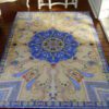 Paisley design miniature rug with deep blue and golden hues