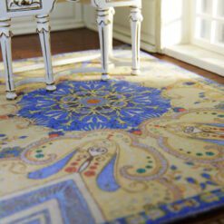 Paisley design miniature rug with deep blue and golden hues