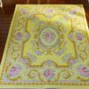 Light yellow Victorian rug with floral details and golden accents