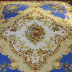 Classic blue Aubusson rug with floral details and a central medallion design.