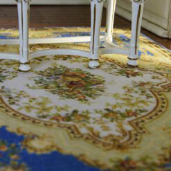 Classic blue Aubusson rug with floral details and a central medallion design.