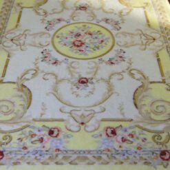 Light yellow Victorian rug with floral motifs and golden accents