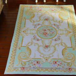 Soft green Victorian rug with rose motifs and gold accents