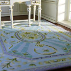 Light blue and green Aubusson rug with a central floral medallion and geometric patterns.