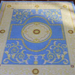 Simple French Aubusson miniature rug with soft floral motifs and scrollwork in cream and green