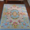 Victorian Rococo miniature rug with pastel florals and gold scrolls