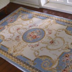 Victorian miniature rug in light blue with floral medallion