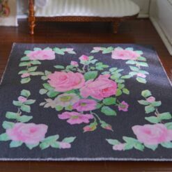 Dark grey miniature rug with pink roses and green vines