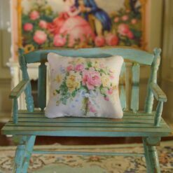 Miniature pillow with pastel floral bouquet and blue ribbon