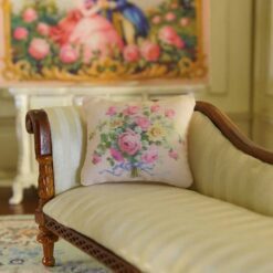Miniature pillow with pink and yellow rose bouquet tied with blue ribbon