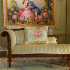Miniature pillow with pink roses and yellow flowers framed by ornate gold