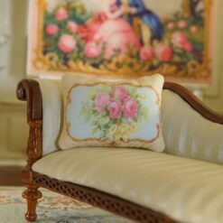 Miniature pillow with pink roses and yellow flowers framed by ornate gold