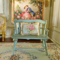 Miniature pillow with pink roses and yellow flowers framed by ornate gold