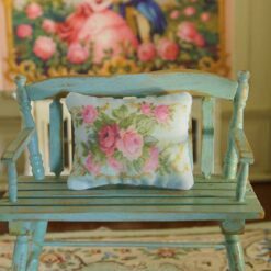 Miniature pillow featuring pink and red roses with golden scroll accents