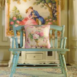 Miniature pillow featuring a golden vase with red, white, and pink roses