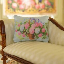 Miniature pillow featuring a basket of roses with blue ribbons