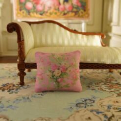 Miniature pillow with pink and yellow roses in a silver vase surrounded by green vines