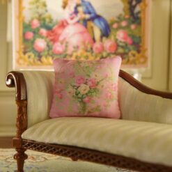 Miniature pillow with pink and yellow roses in a silver vase surrounded by green vines