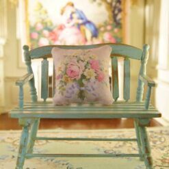 Miniature pillow with pink and yellow roses tied with blue ribbon