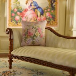 Miniature pillow with pink and yellow roses tied with blue ribbon
