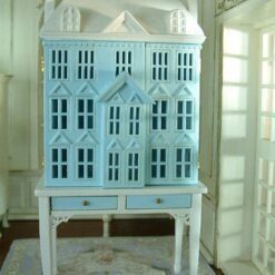 Blue townhouse-style miniature dollhouse with white table