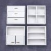 Set of four miniature wooden cabinets in various finishes for dollhouse storage