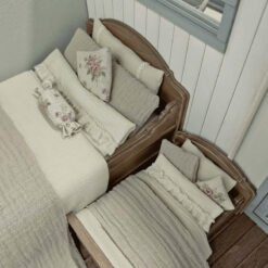 A vintage dollhouse bed with a cozy and detailed design.