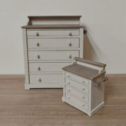 A vintage-style dollhouse chest of drawers with five compartments.