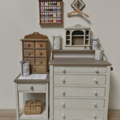 A vintage-style dollhouse chest of drawers with five compartments.