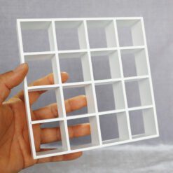 16-grid miniature shelving unit available in black and white finishes.