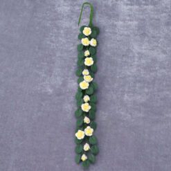 White miniature garden arbor with slatted bench, perfect for dollhouse outdoor scenes.