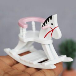 Miniature wooden rocking horse with blue detailing for dollhouse nurseries.