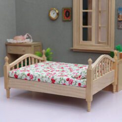 Miniature wooden bed with floral bedding for dollhouse