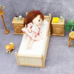 Miniature wooden bed with green bedding for dollhouse