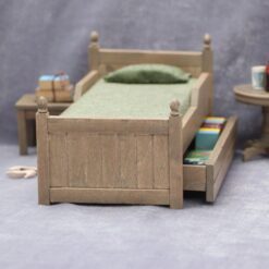 Miniature wooden bed with green bedding for dollhouse
