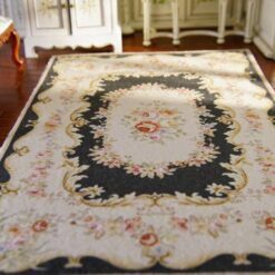 Aubusson style miniature rug in black with intricate floral motifs