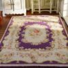 ubusson style miniature rug in purple with floral motifs and delicate detailing
