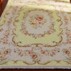 Yellow Aubusson style miniature rug with floral pattern and scroll detailing