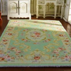 Miniature Victorian rug in soft green with floral patterns and medallion detail.