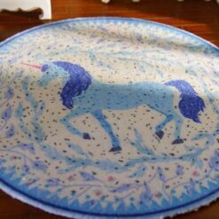 Miniature unicorn rug featuring a blue unicorn within a floral wreath.