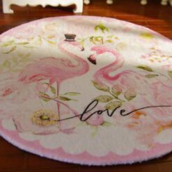 Miniature rug with two pink flamingos surrounded by floral elements and soft colors.