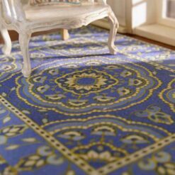 Persian miniature rug with a blue background, floral medallion, and intricate borders.